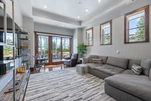 Room featuring wood-finish flooring, recessed lighting, and a tray ceiling