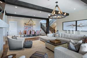 Spacious living area featuring exposed wood beams and recessed lighting