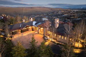 Expansive residence featuring a stone and wood exterior with multiple gables