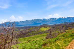 Expansive mountain terrain featuring snow-capped peaks in the distance