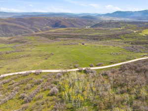 Expansive natural landscape featuring rolling hills and distant mountains