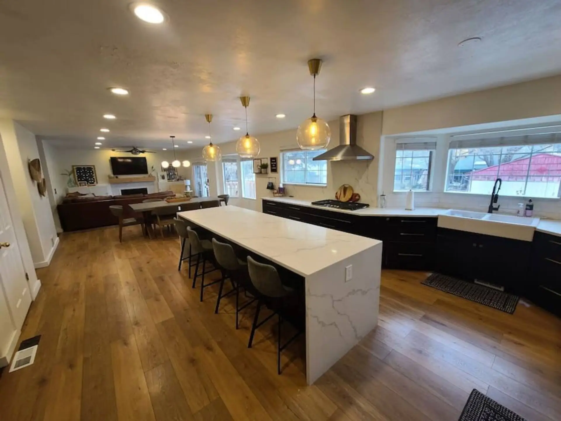 Open-concept kitchen and living area featuring wood-finish flooring