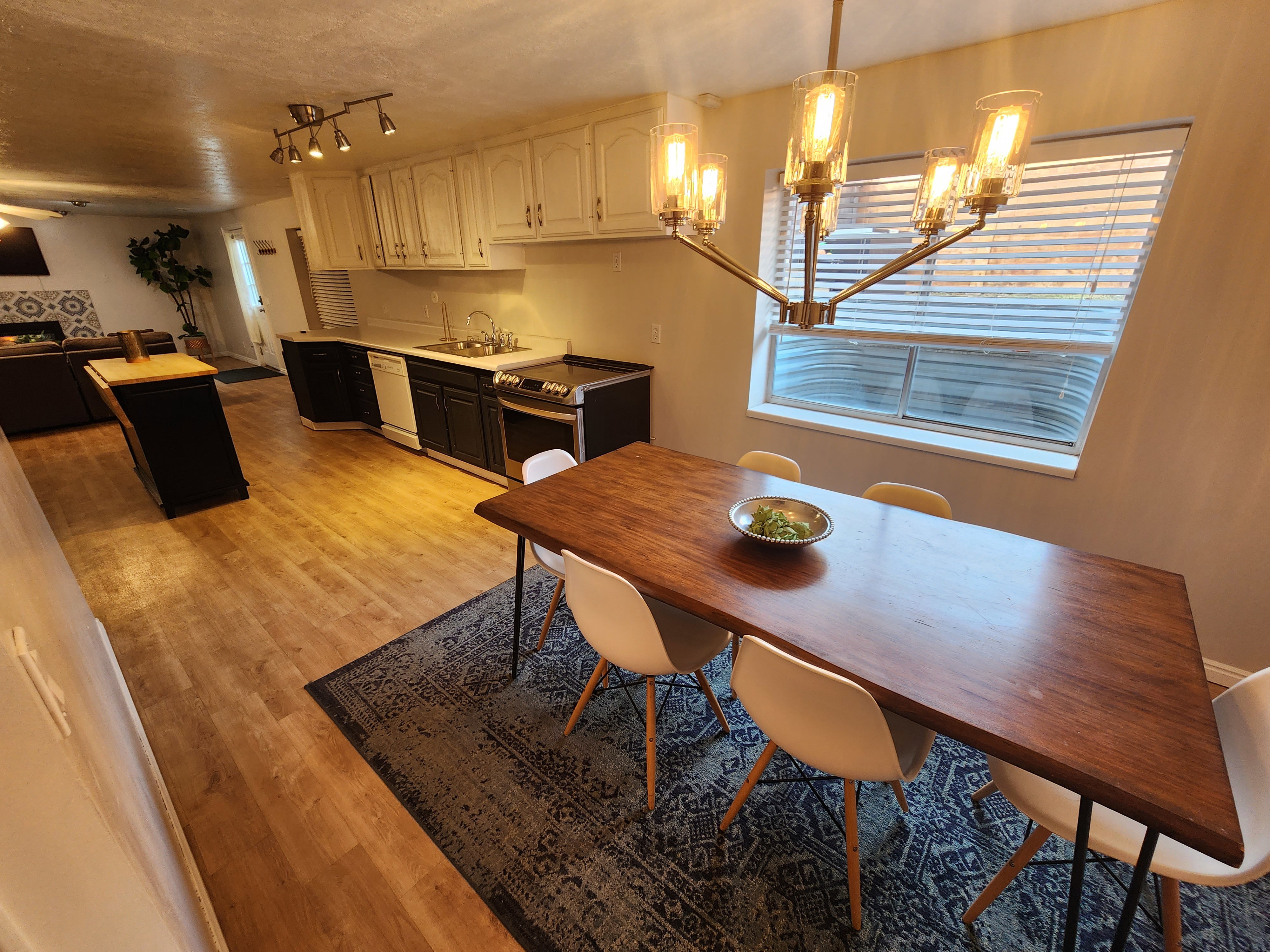 Open-concept living space with wood-finish flooring extending into the kitchen
