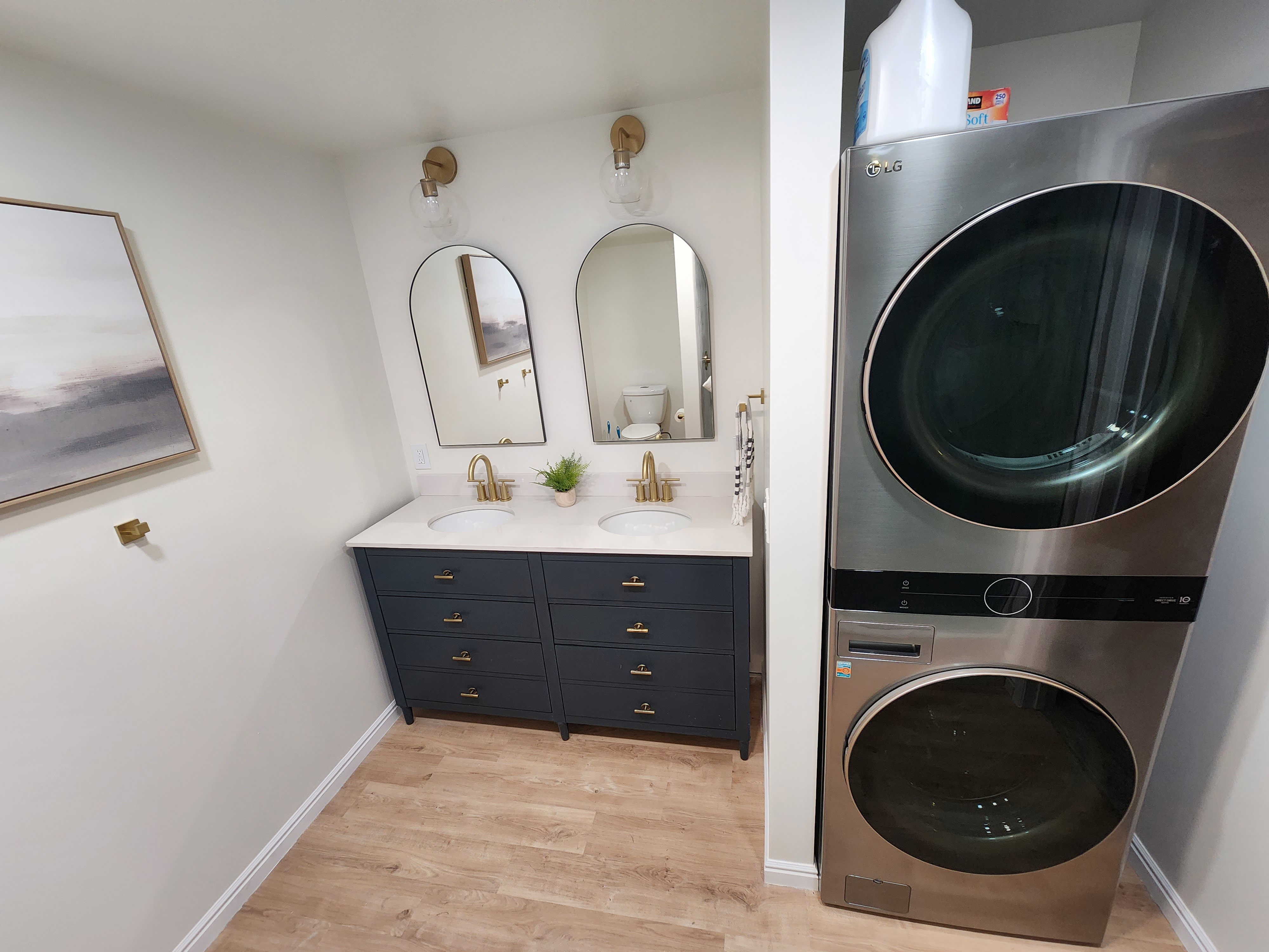 Dual vanity with a white countertop and gold-finish fixtures