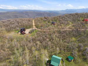Mountainous terrain with natural tree coverage and multiple structures