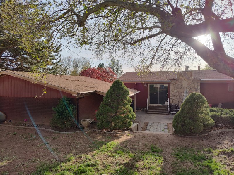 Rear exterior with red siding and stone accents