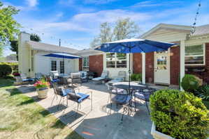 Expansive concrete patio offering direct access to the interior via French doors and a single entry door
