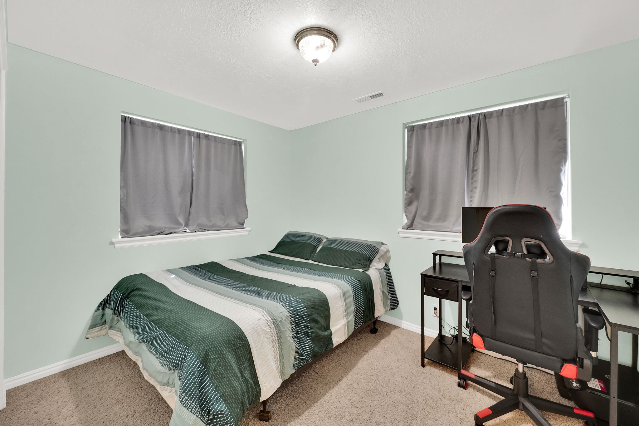 Bedroom featuring light-colored walls and carpet flooring
