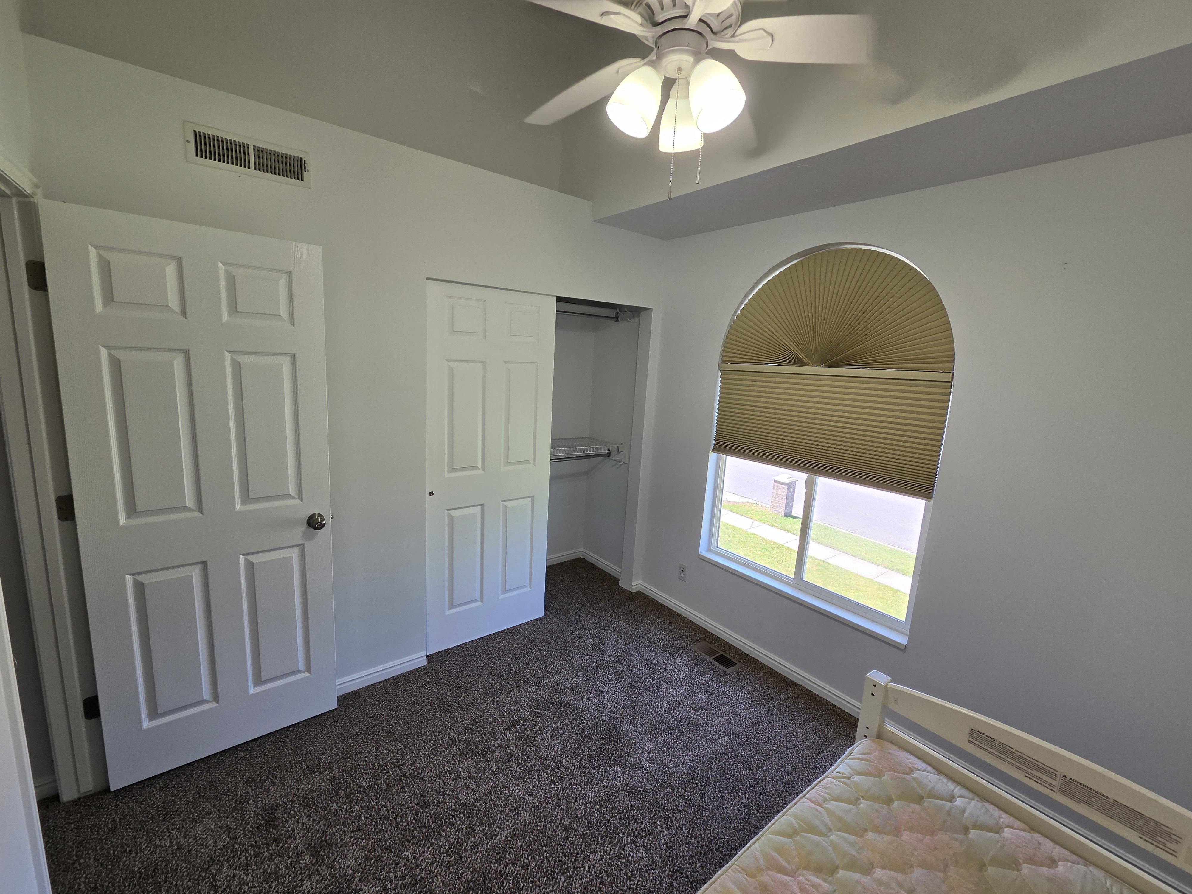 Room featuring a vaulted ceiling and a ceiling fan