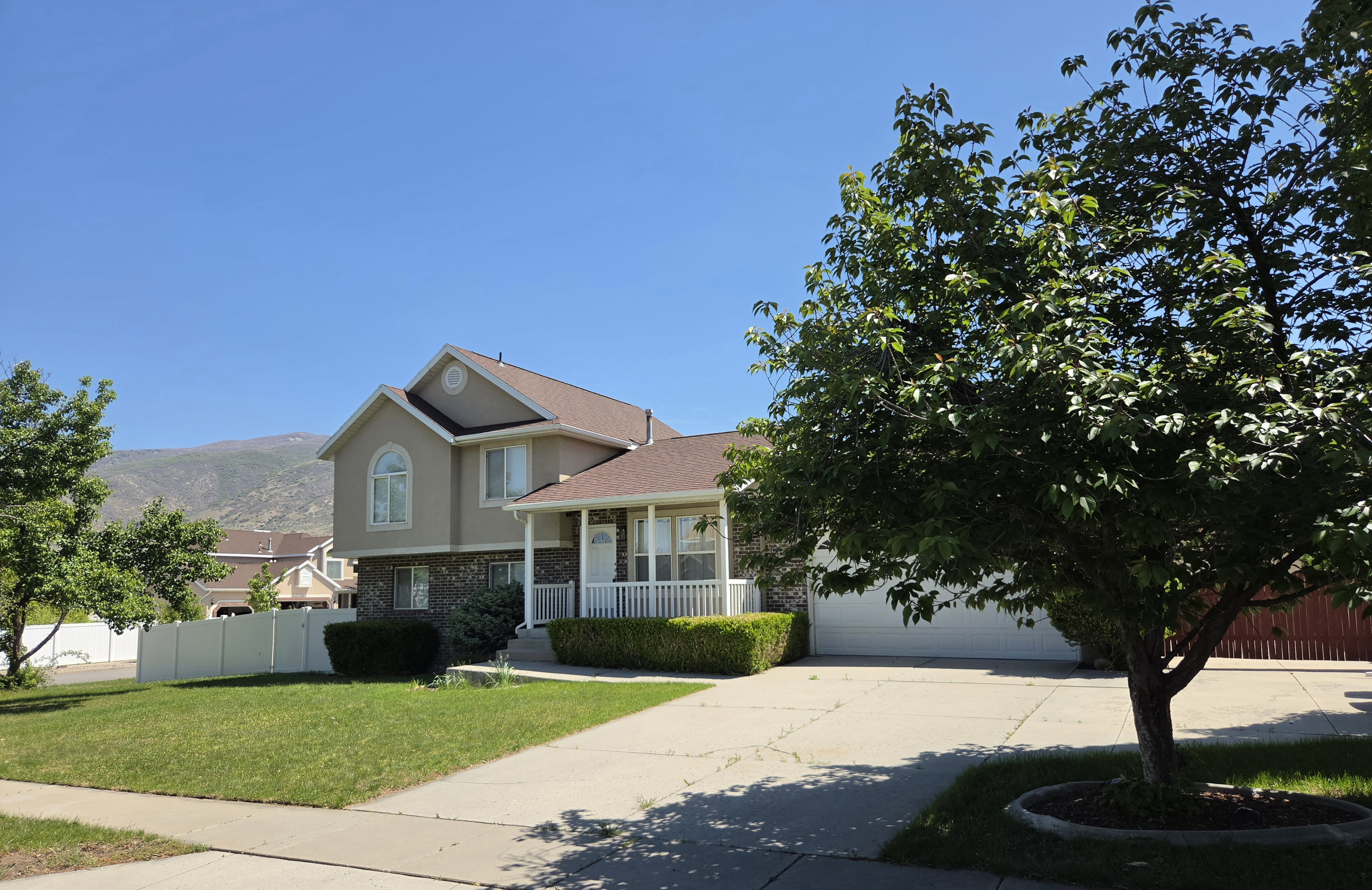 Two-story residence featuring a covered front porch, a two-car garage, and a concrete driveway