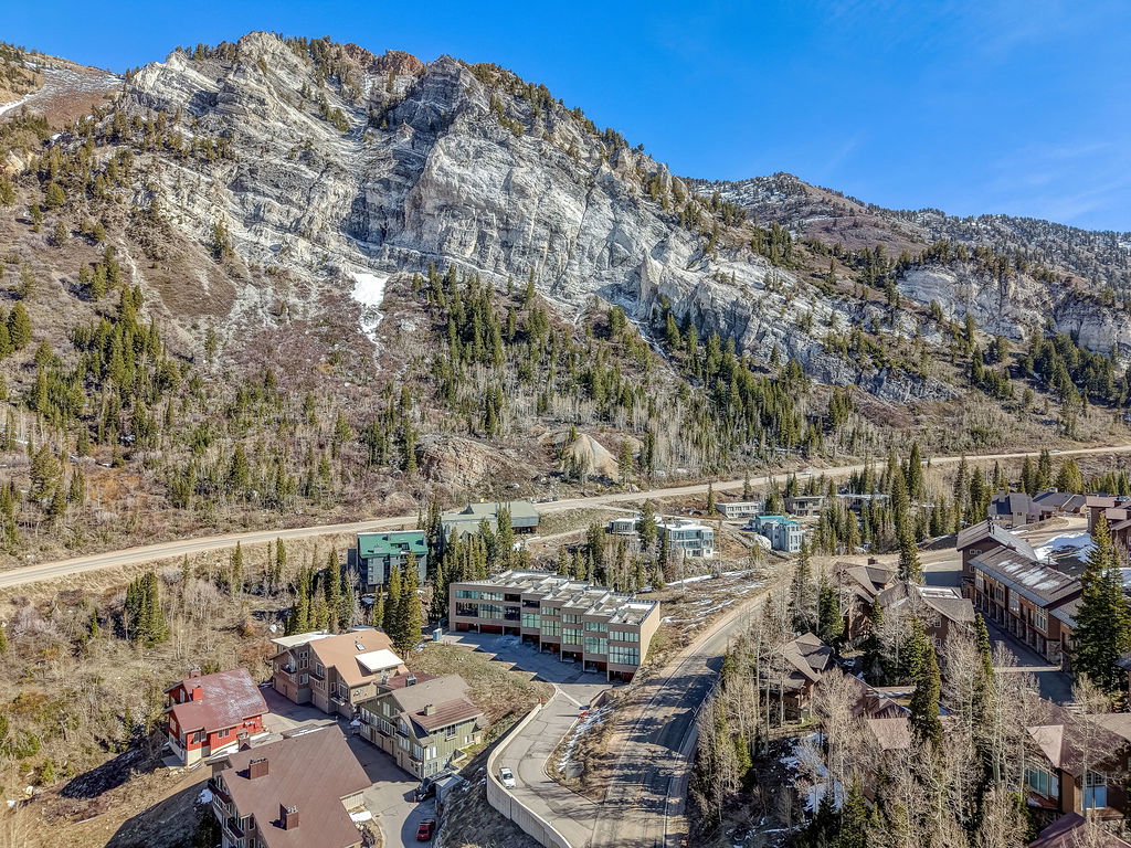 Mountainous terrain with natural rock formations and scattered evergreen trees