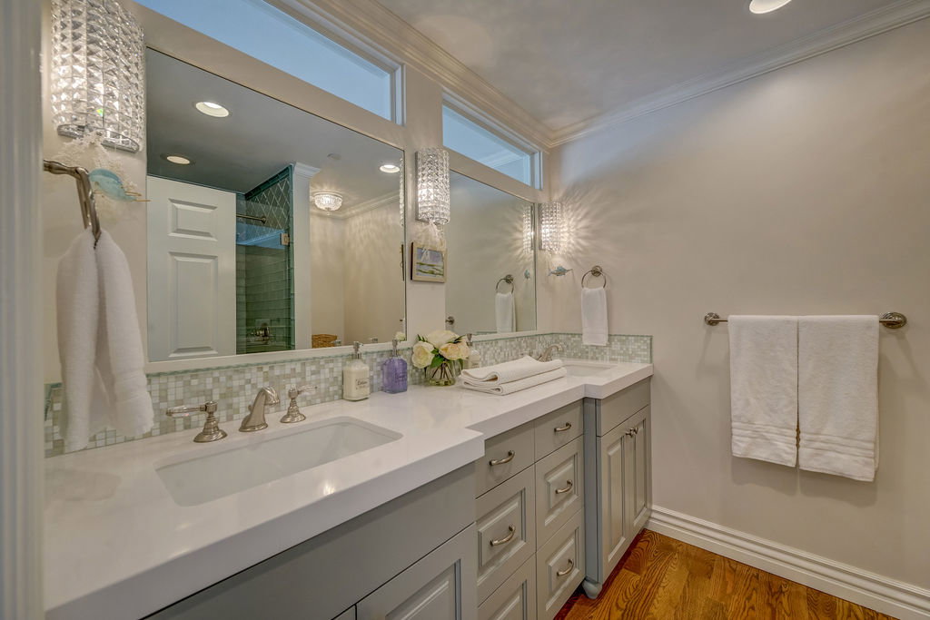 Double vanity with integrated sinks and white countertops