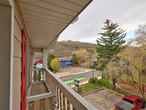 Private balcony with wood railing and mountain backdrop
