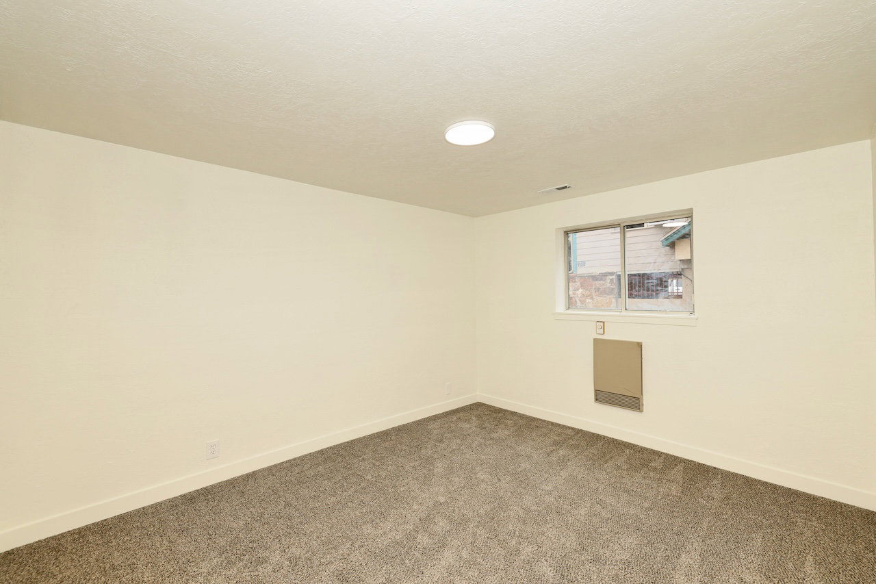 Neutral-toned walls complementing plush grey carpeting