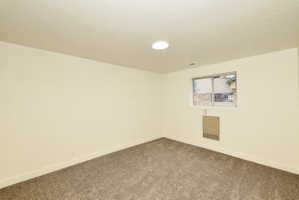 Neutral-toned walls complementing plush grey carpeting