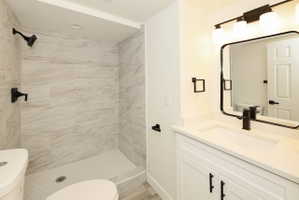 Walk-in shower with large format tile surround and hexagonal floor tiles