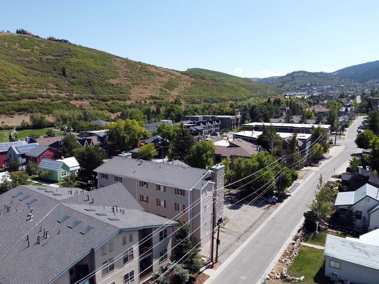 Aerial perspective showcasing a community nestled against a verdant hillside