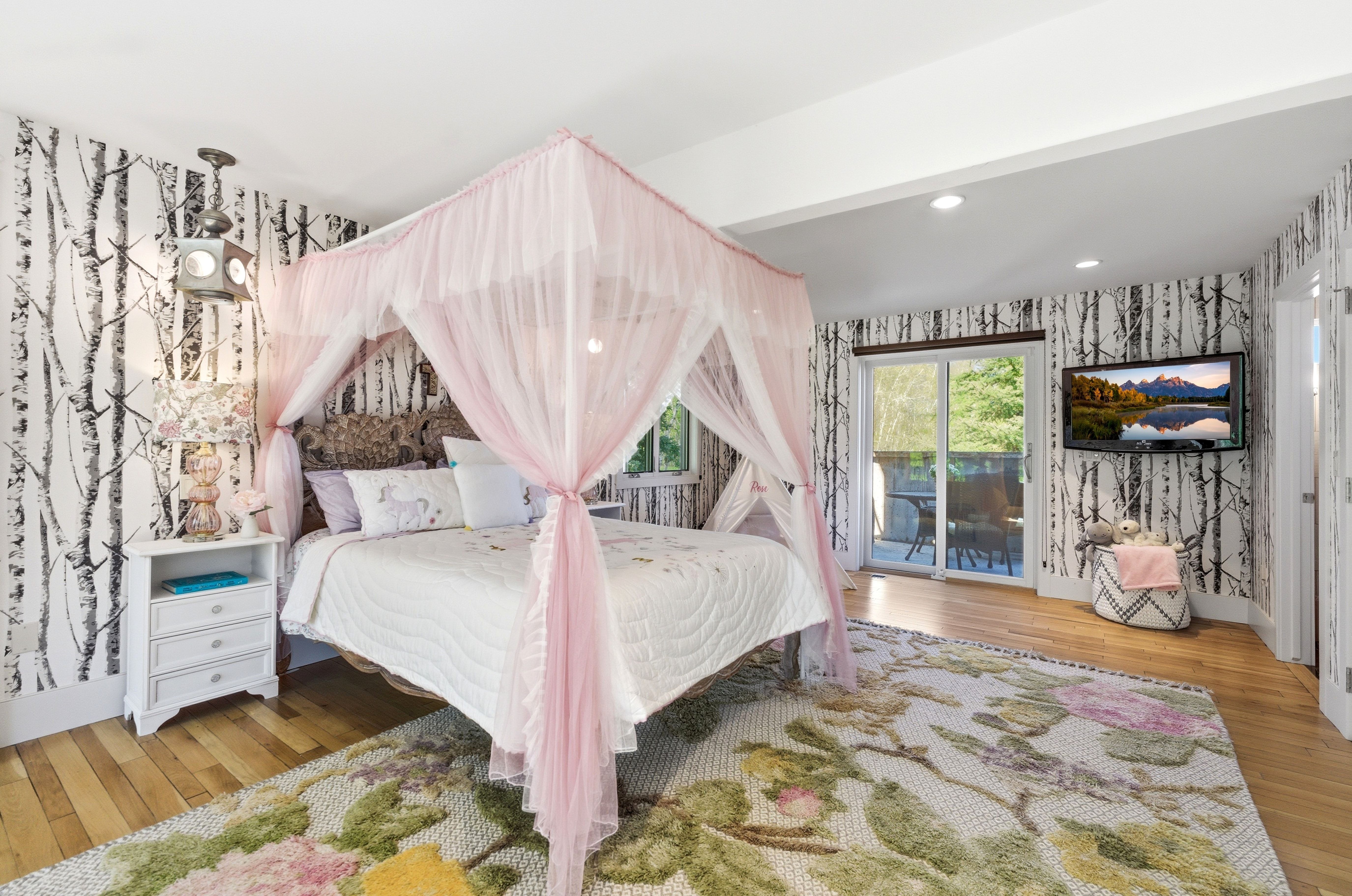 Bedroom featuring wood-finish flooring, recessed lighting, and sliding glass doors opening to an exterior space
