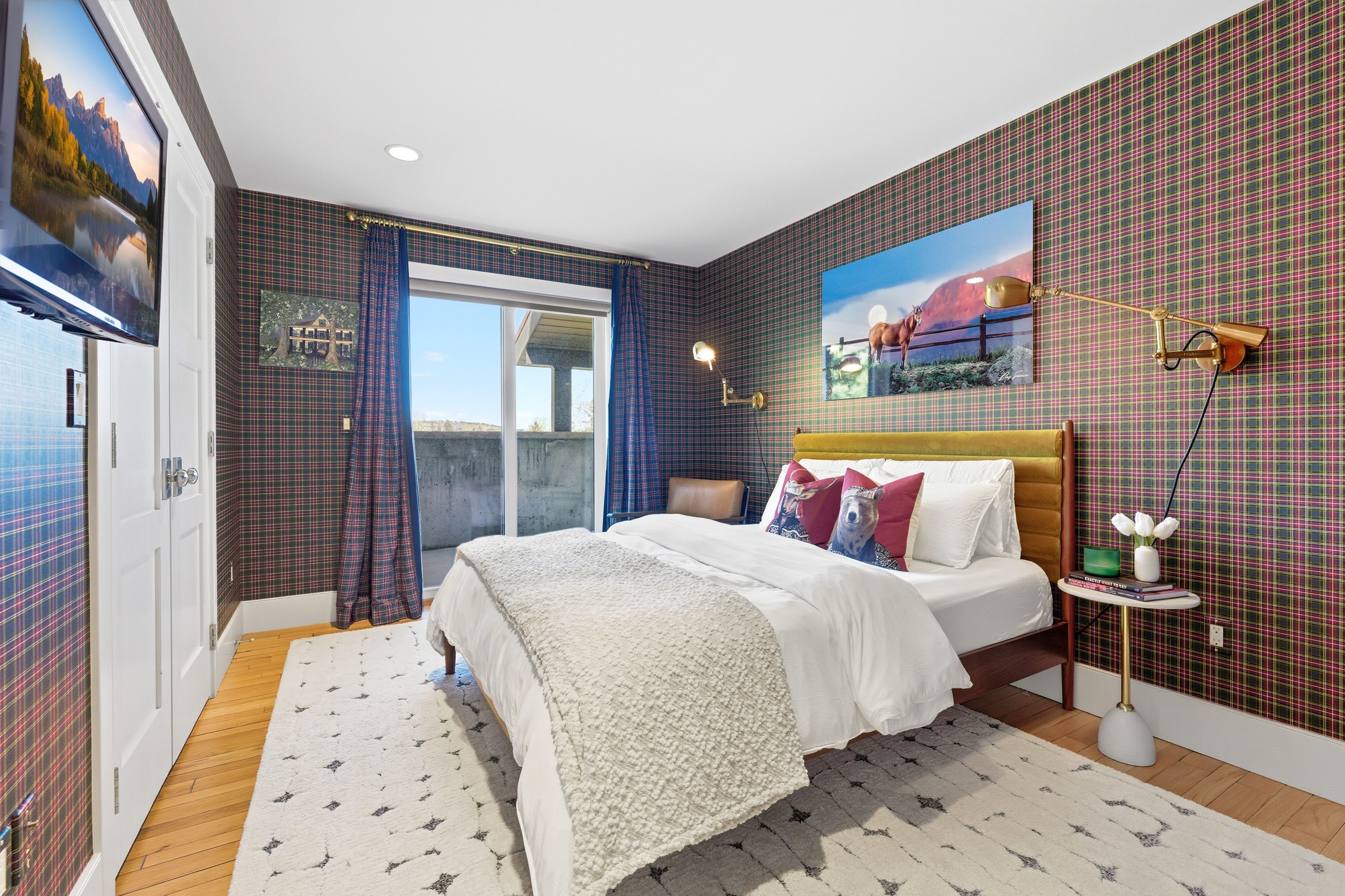 Bedroom featuring plaid pattern wall covering, wood-finish flooring, a sliding glass door providing exterior access, and recessed lighting