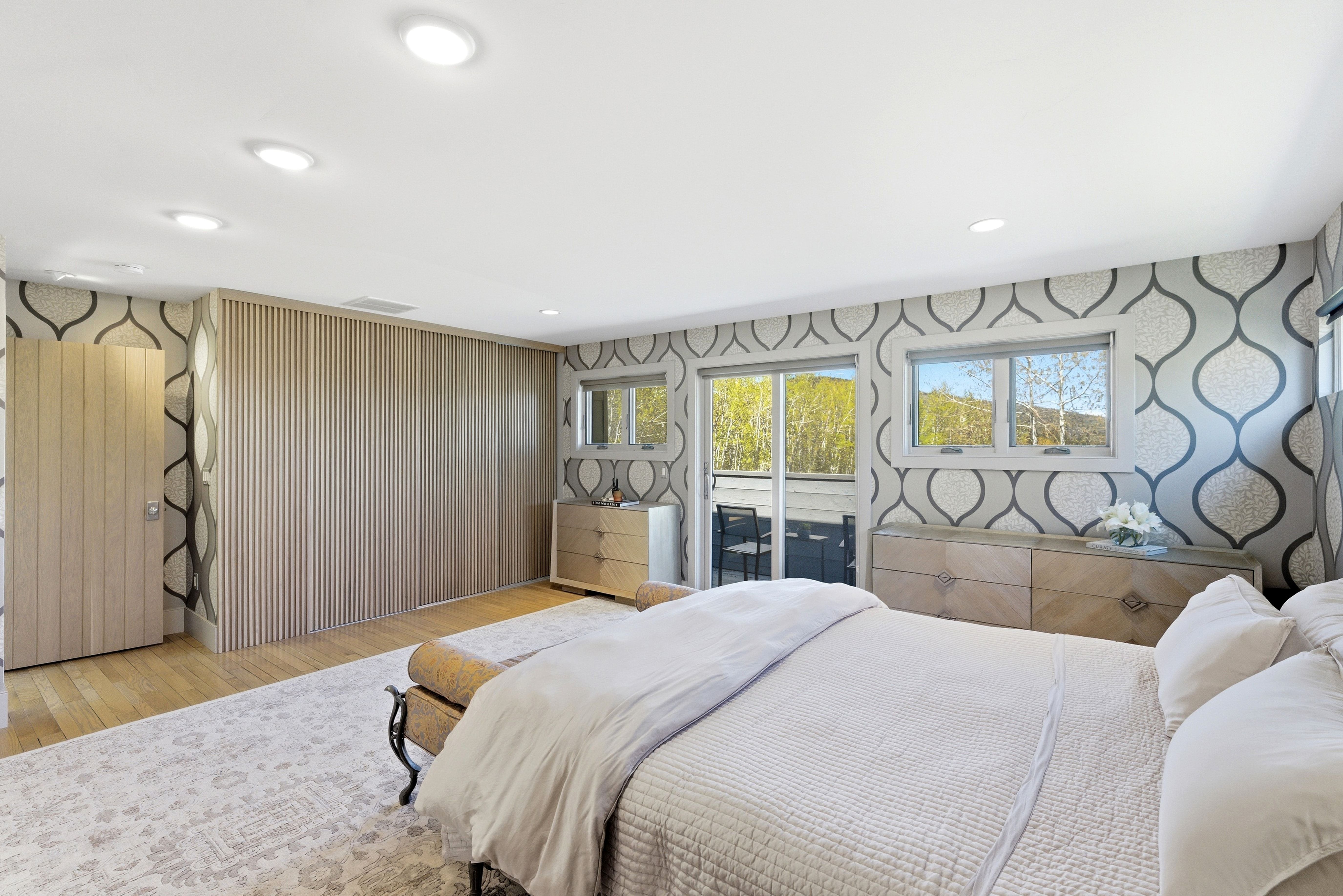 Wood-finish flooring throughout this room featuring a full wall of integrated cabinetry