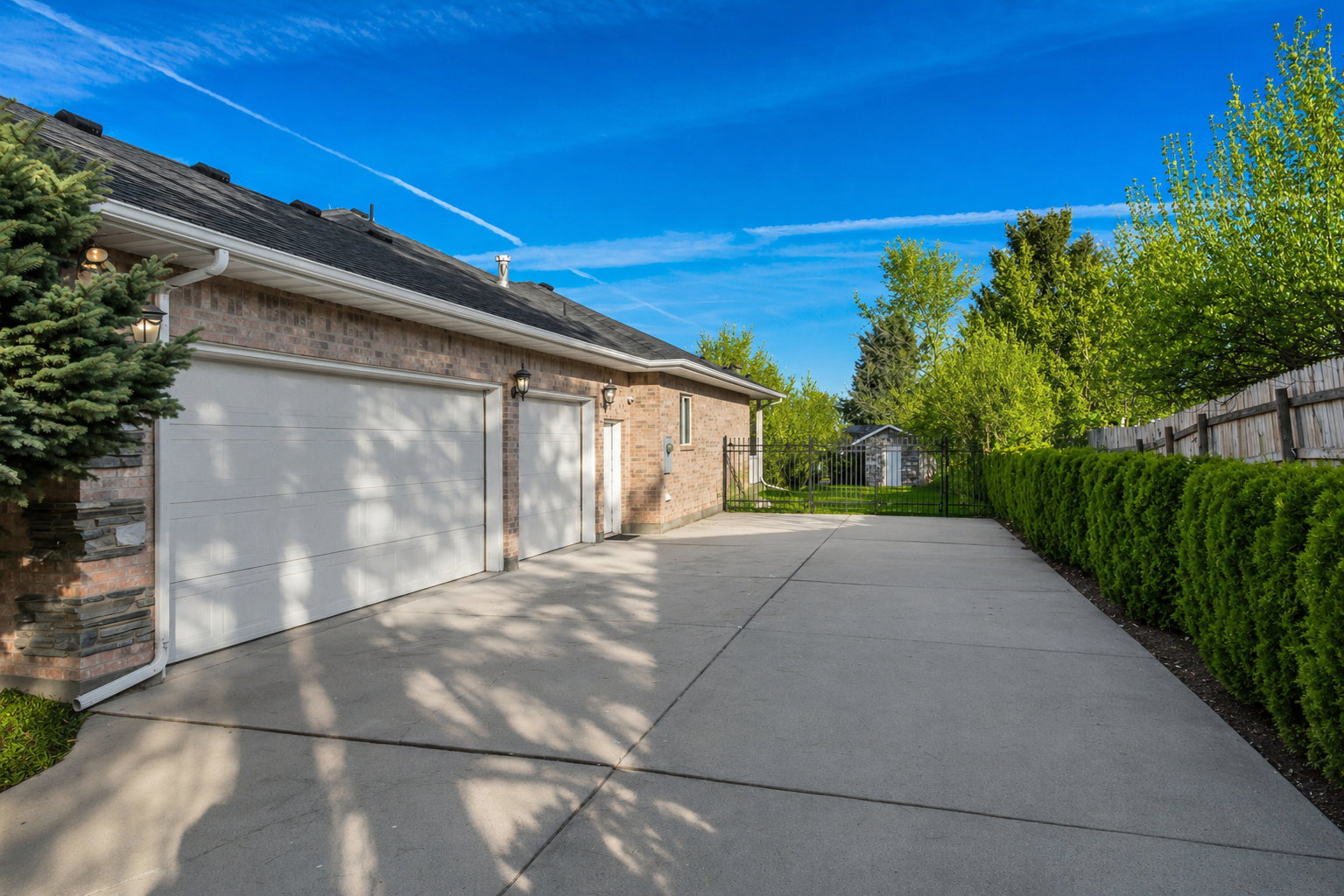 Expansive concrete driveway with a two-car garage