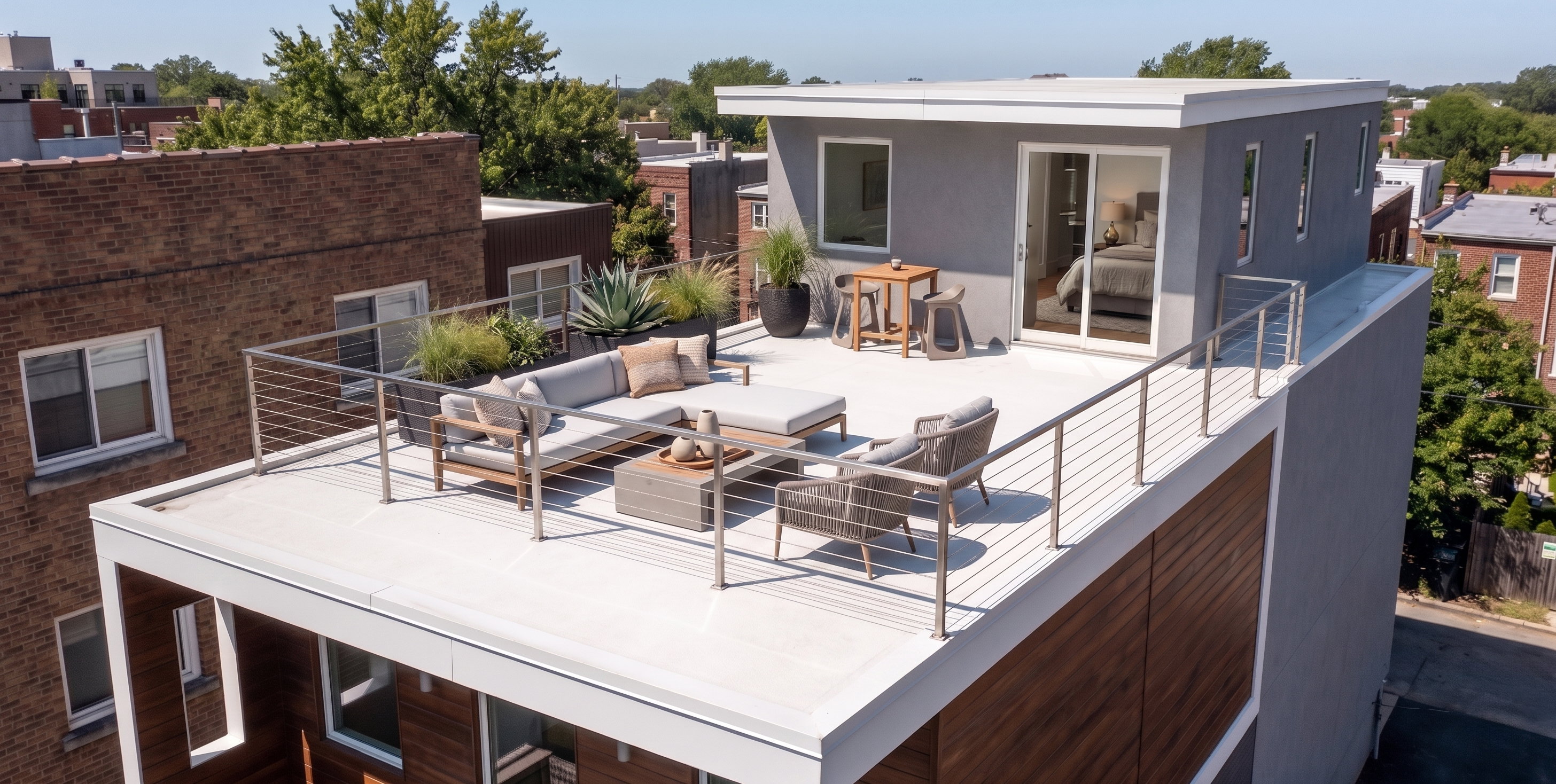 Rooftop terrace featuring a modern cable railing system and direct access to an upper-level room through a glass sliding door