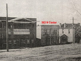 Historical Property Photograph. Displaying an urban streetscape with multiple structures and an address identifier