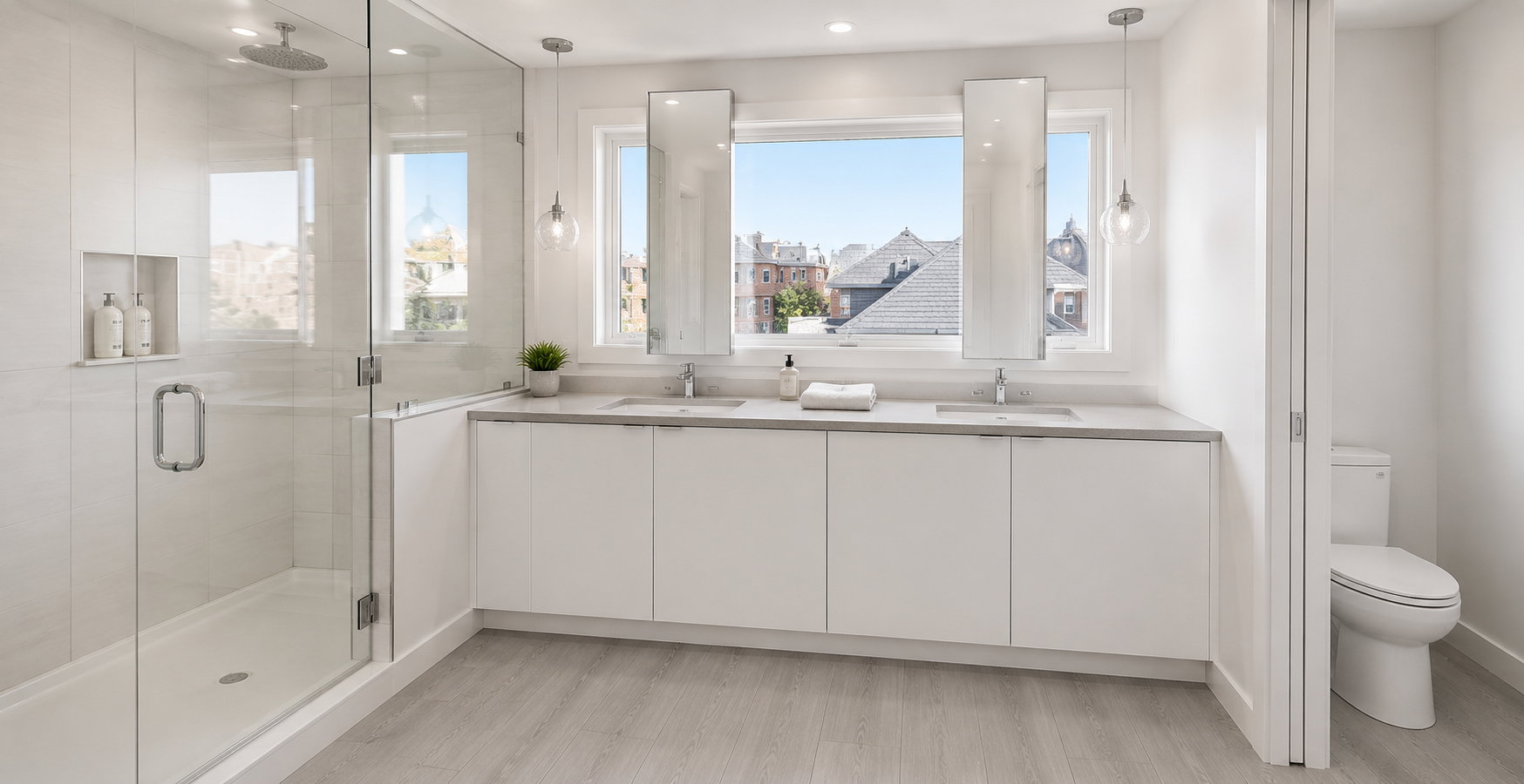 Contemporary bathroom featuring a spacious glass-enclosed shower with a built-in niche, dual floating vanities with undermount sinks, and two large windows