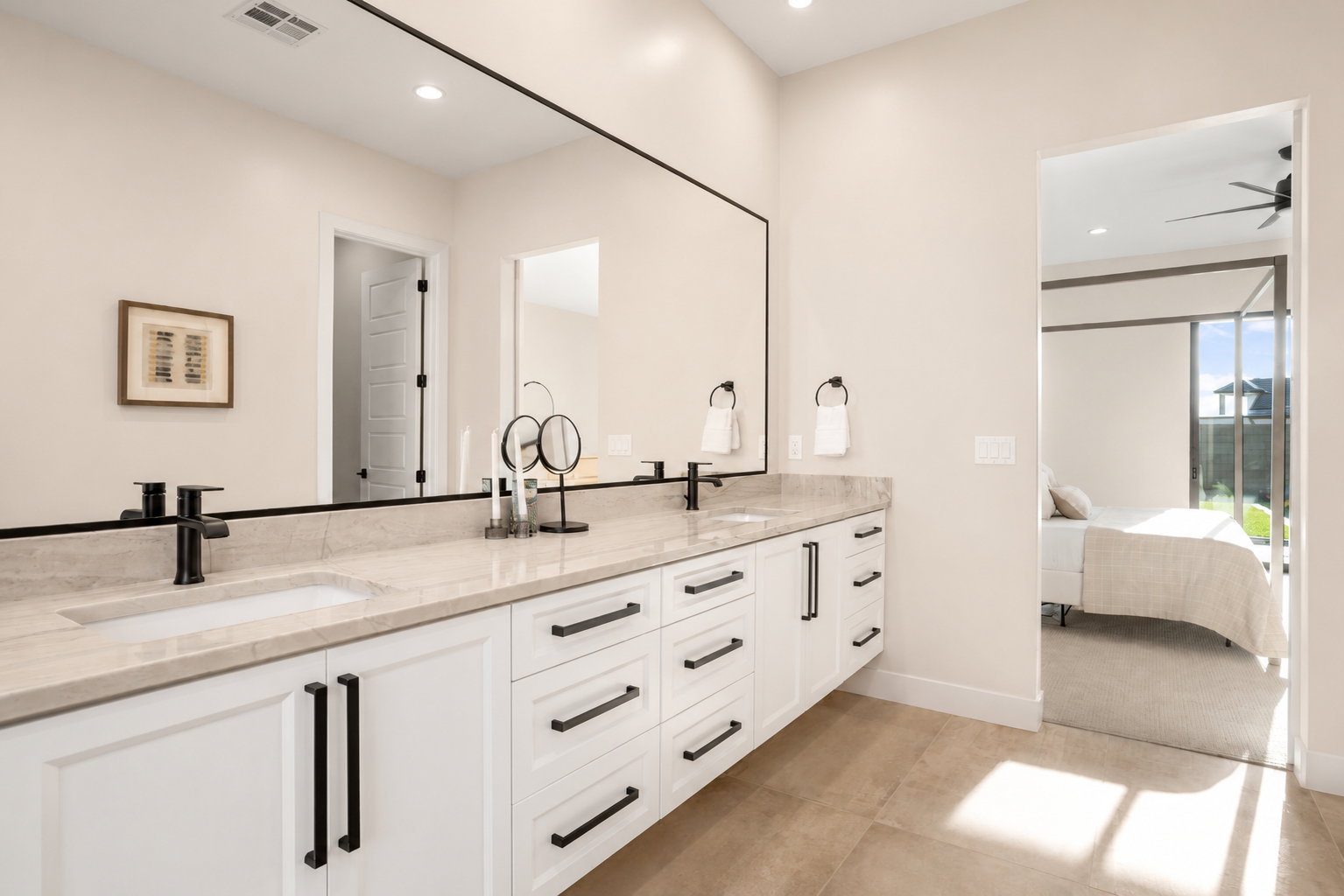 Double vanity featuring light-toned countertops and integrated sinks
