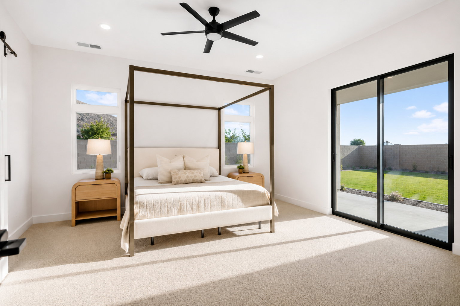 Spacious room featuring broad sliding glass doors opening to a concrete patio and lawn