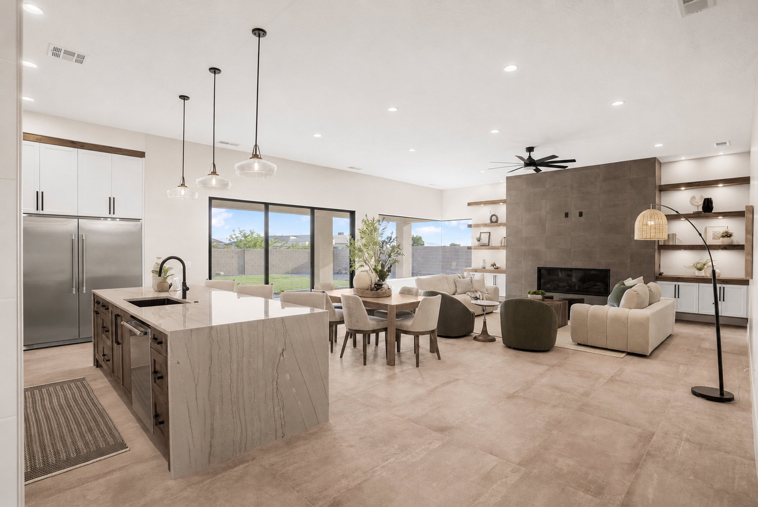 Open-concept great room with large format tile flooring and abundant natural light