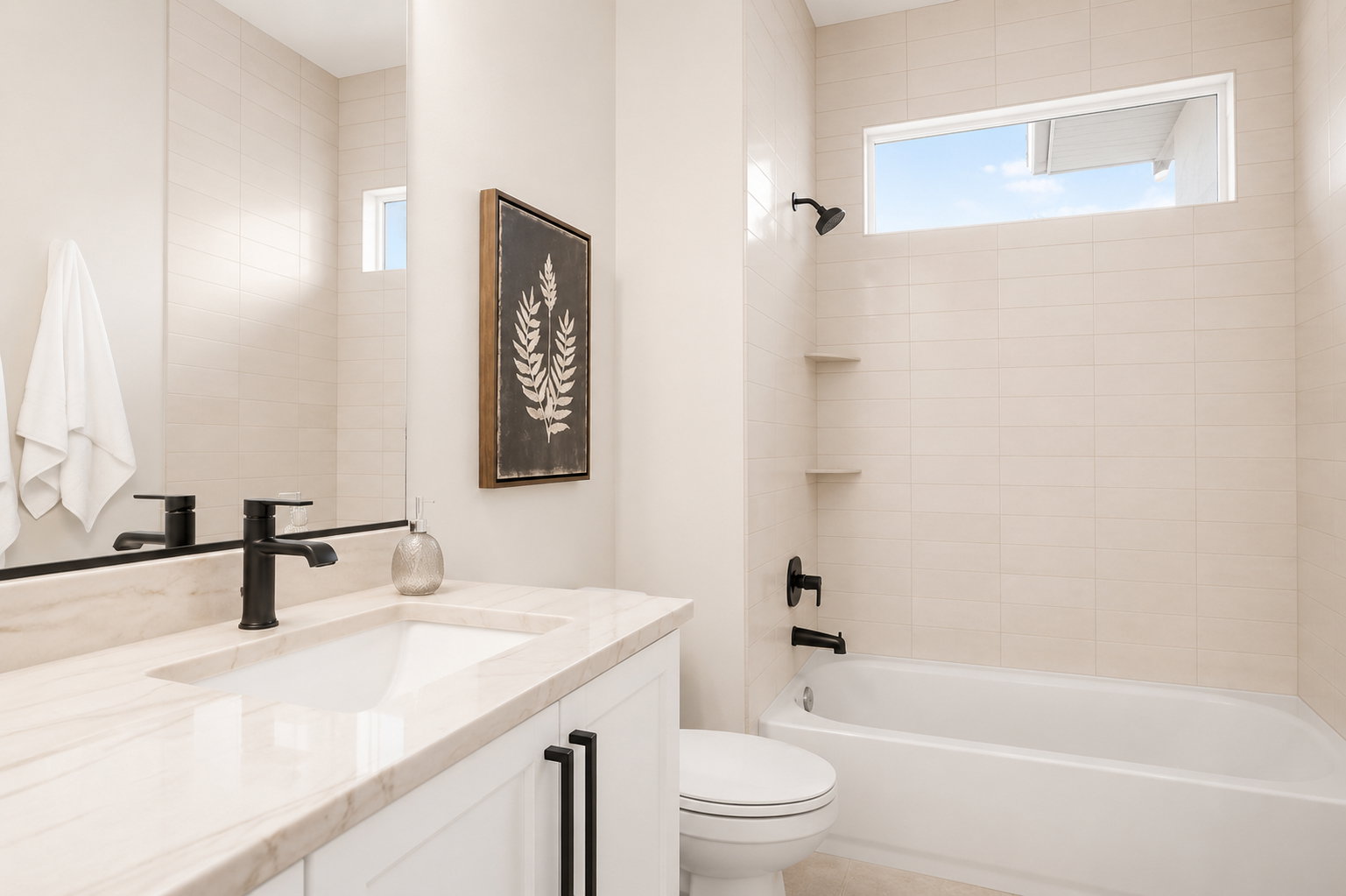 Bathroom featuring a white vanity with a light-toned countertop, an integrated sink, and matte black fixtures