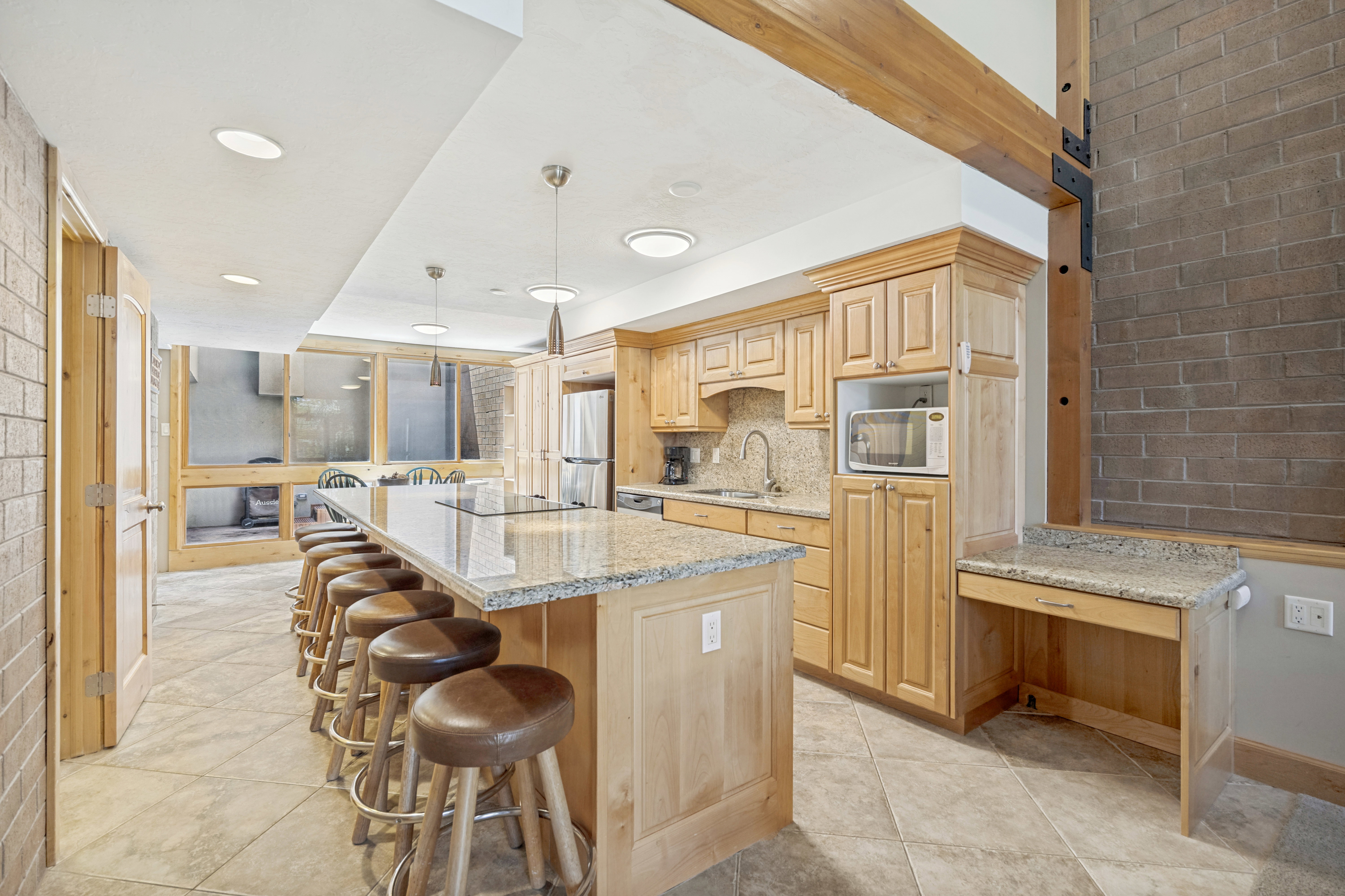 Spacious kitchen featuring an extended island and an additional desk/workspace