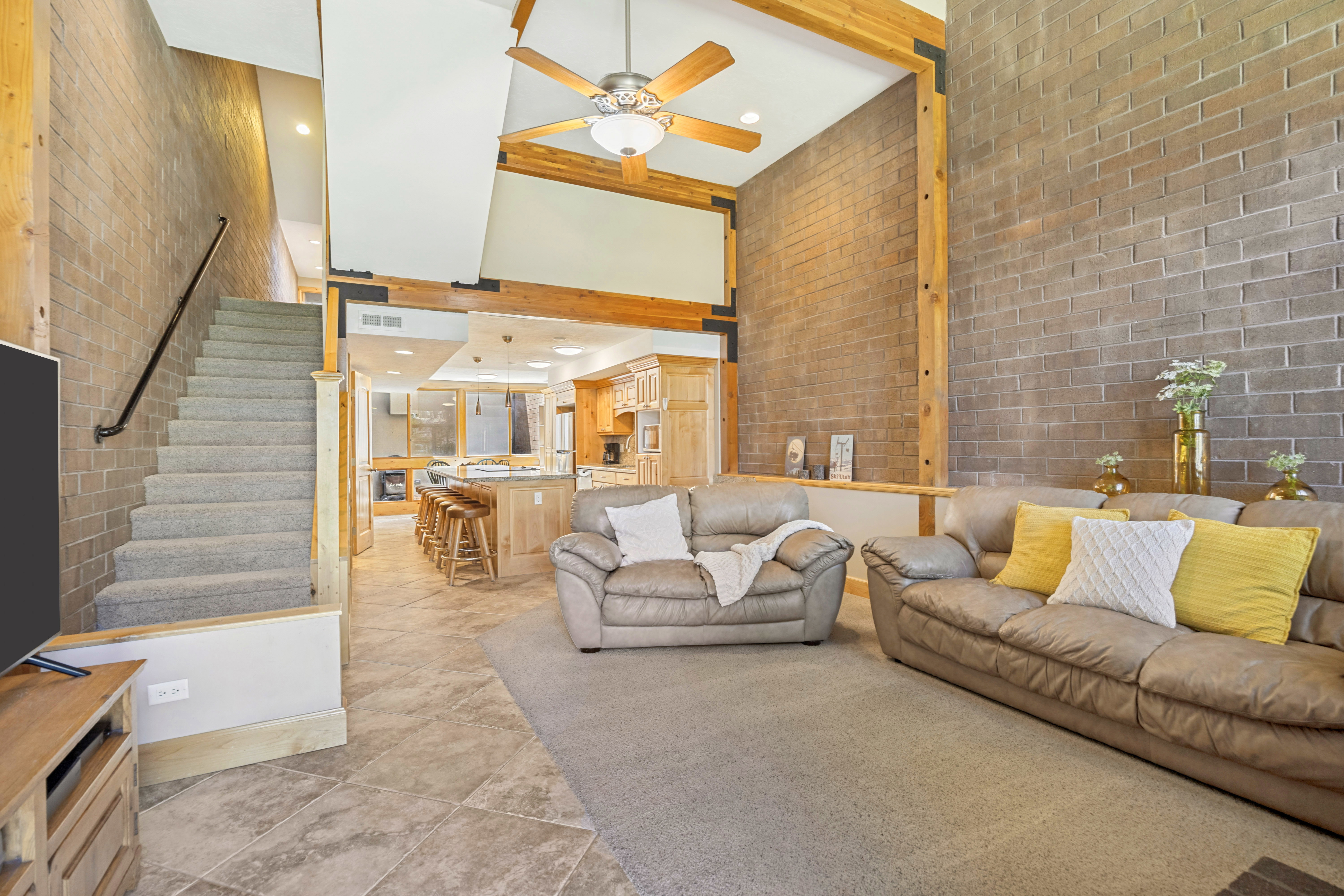 Vaulted family room featuring a high ceiling and exposed wood beams,
