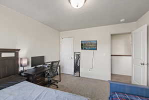 Carpeted spare bedroom featuring light neutral paint and large window