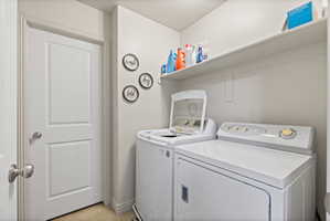 Dedicated second floor laundry area near bedrooms featuring tile flooring, neutral paint, and storage shelf above