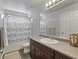 Full bathroom featuring a single vanity with dark wood cabinetry, a light-toned countertop, and an integrated sink