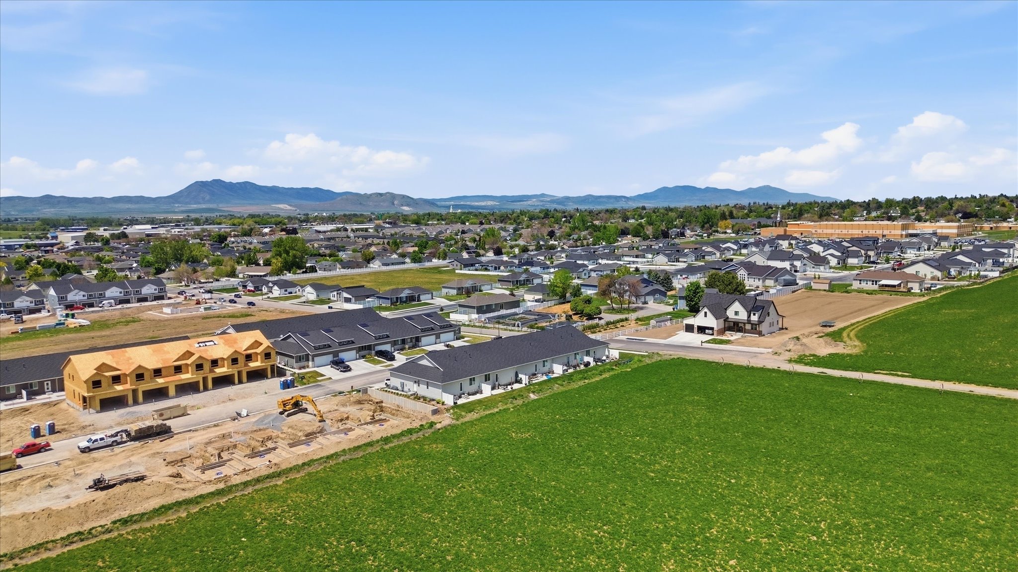 Expansive aerial view showcasing residential development with a mountain backdrop