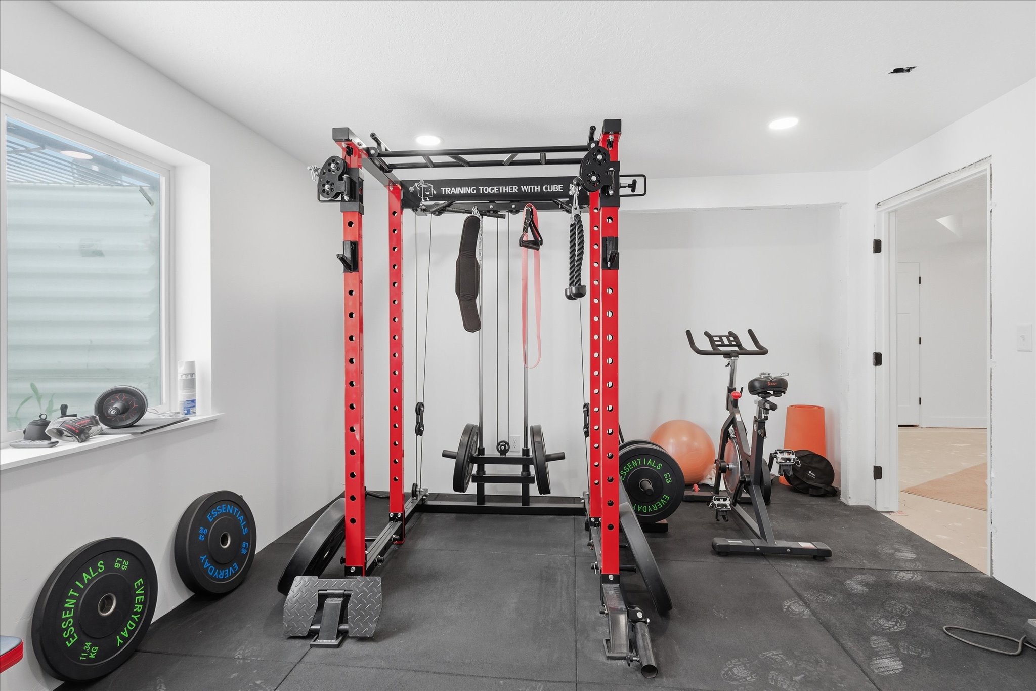 Dedicated fitness room featuring recessed lighting, a window, and durable rubber flooring