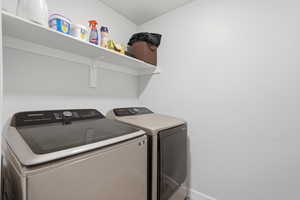 Dedicated laundry area featuring a wall-mounted white shelf
