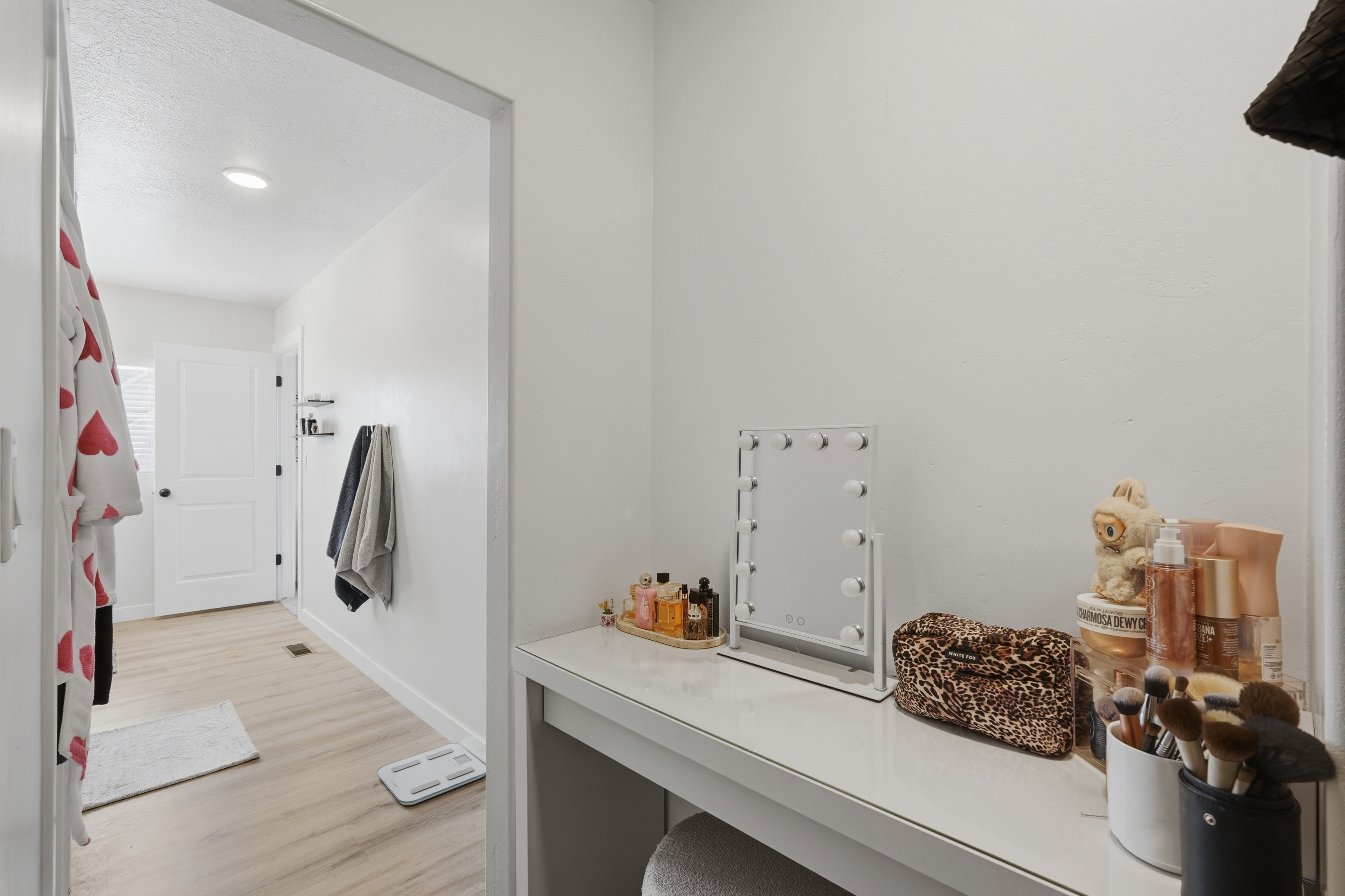 White wall vanity with a solid surface countertop