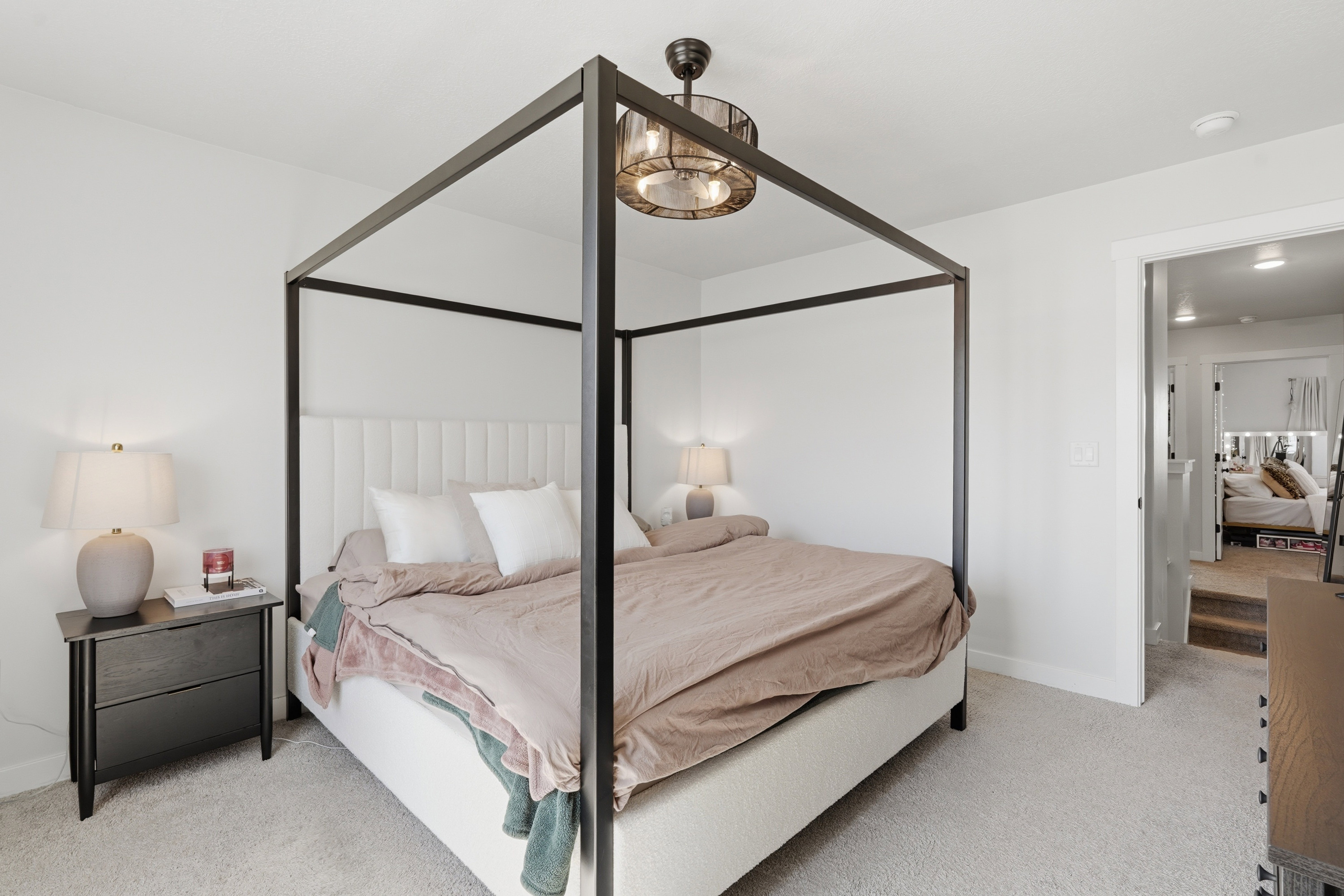 Carpeted bedroom featuring neutral wall paint, a built-in light fixture, and an open doorway