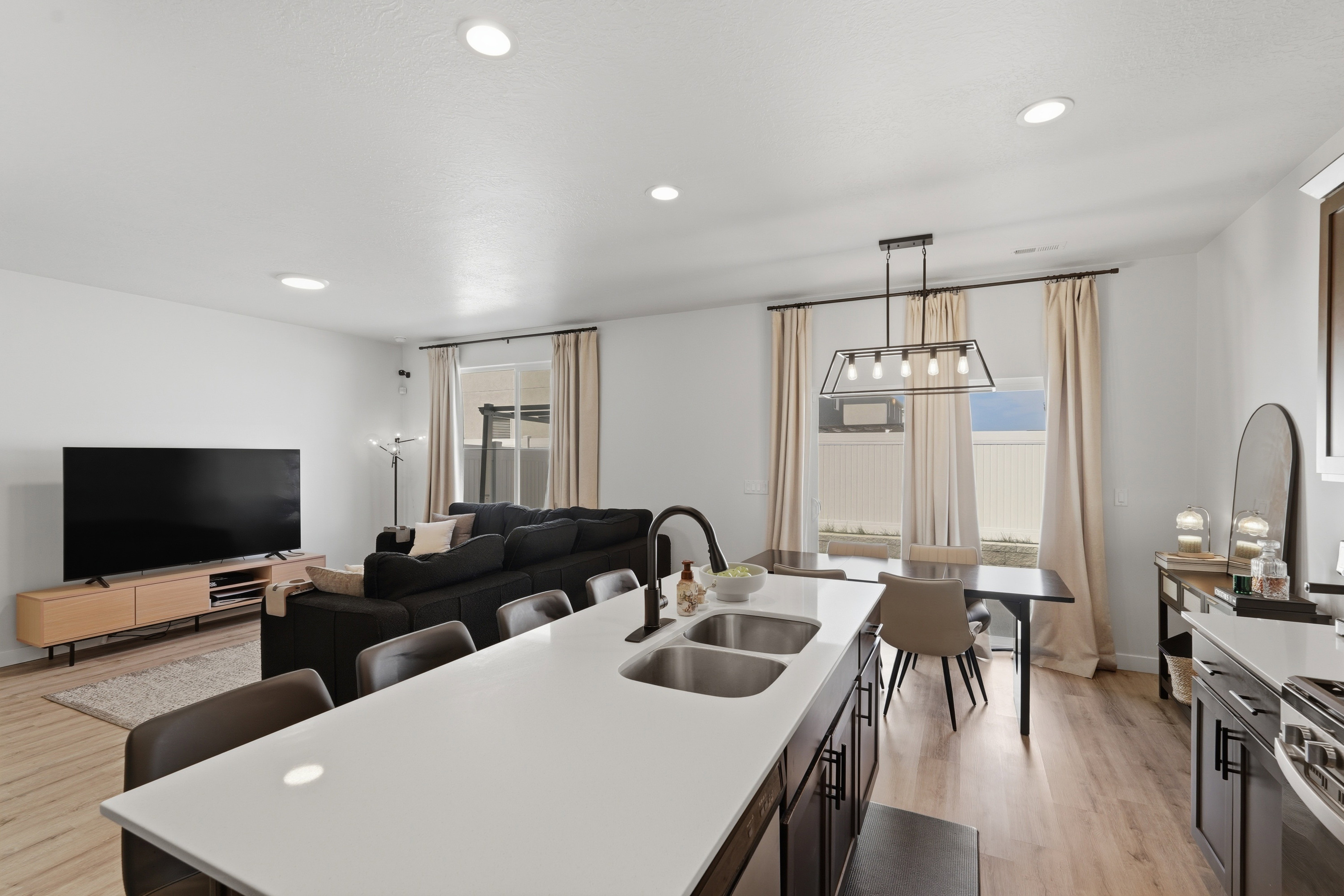 Open-concept living space with recessed lighting and light wood-finish flooring