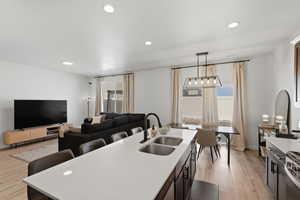 Open-concept living space with recessed lighting and light wood-finish flooring