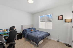 Bedroom featuring a window with white blinds, neutral wall paint, recessed lighting, and carpeted flooring