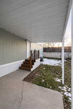 Covered concrete patio with direct entry access