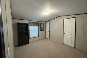 Carpeted room with light neutral walls and dark accent trim