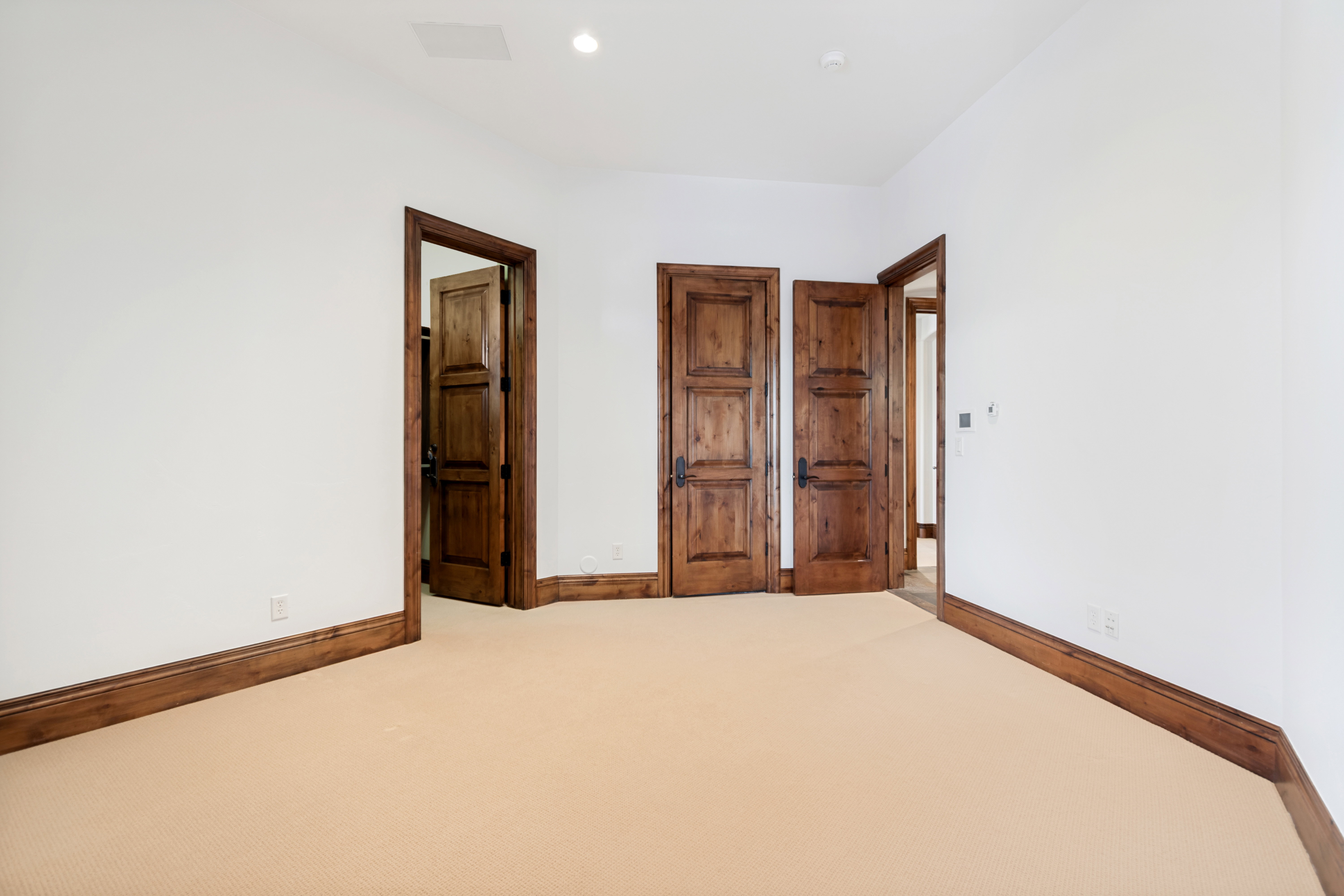 Room featuring light-colored carpeting and white walls