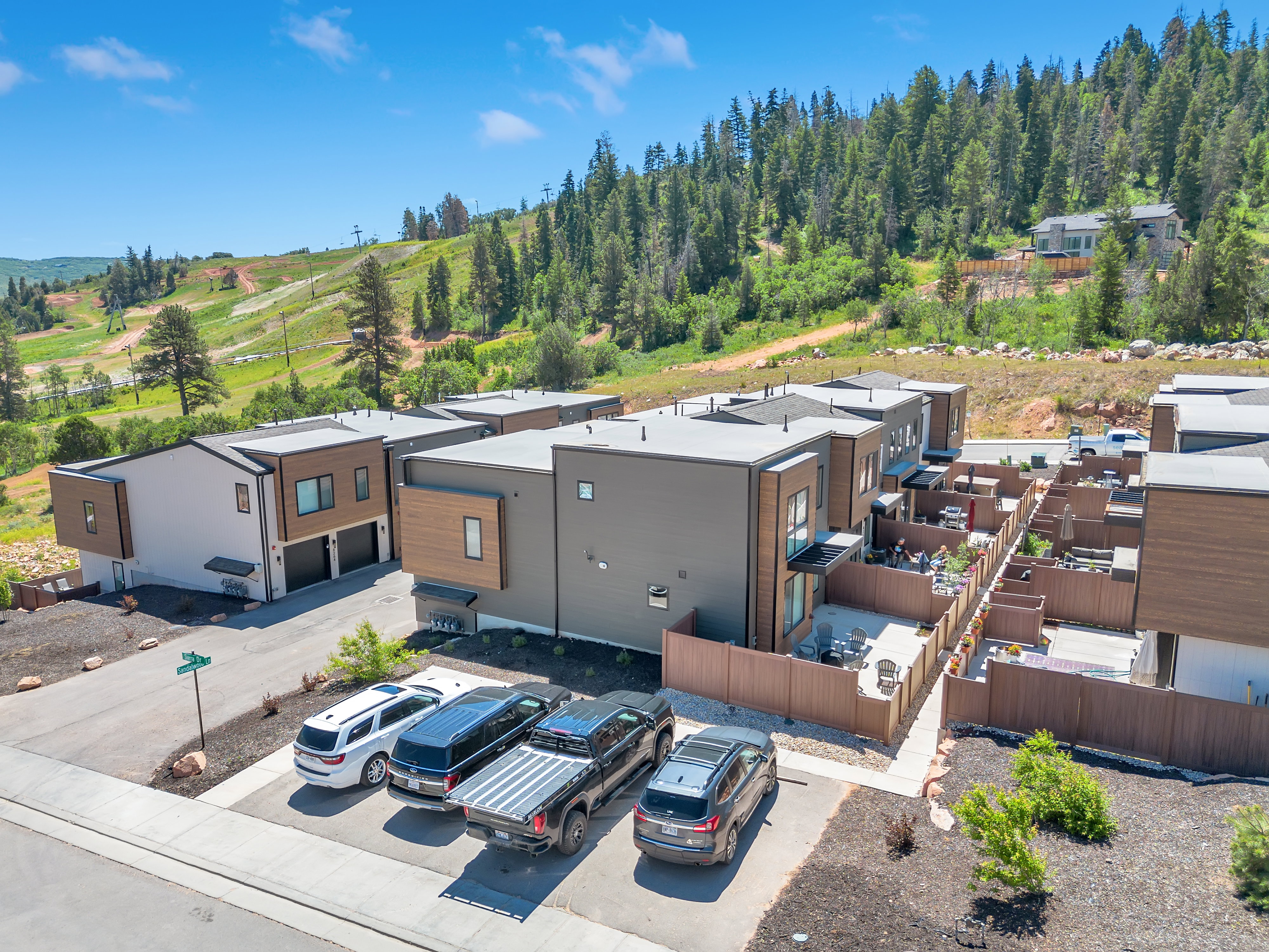 Modern multi-level townhome featuring a contemporary exterior with wood-finish and neutral-toned siding