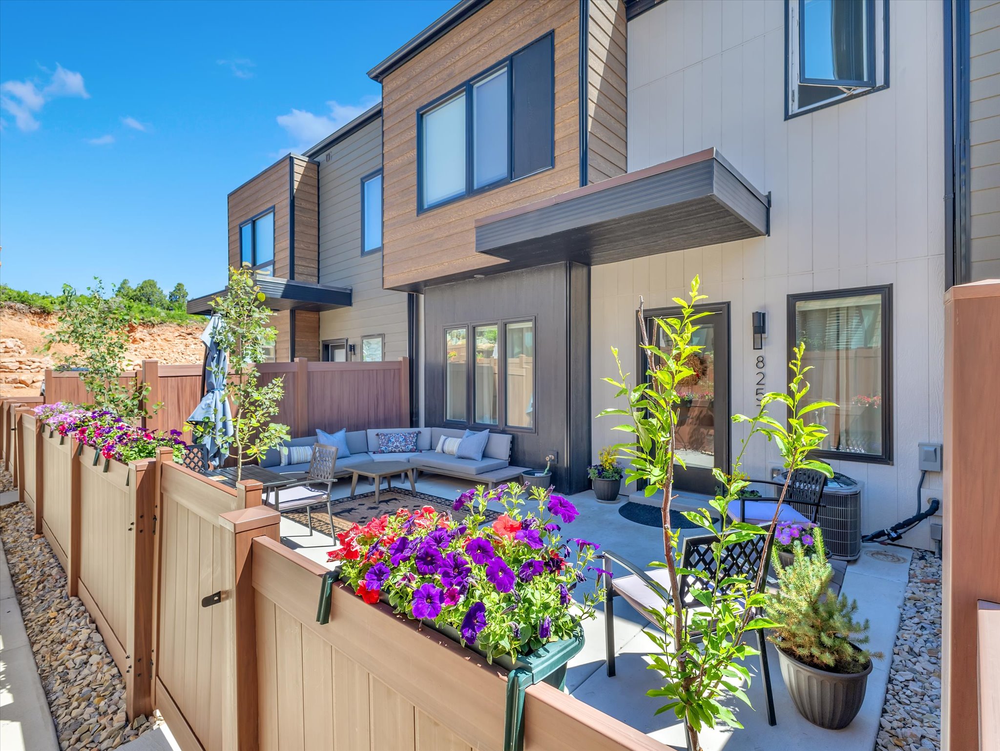 Concrete patio area featuring a privacy fence with integrated planter boxes